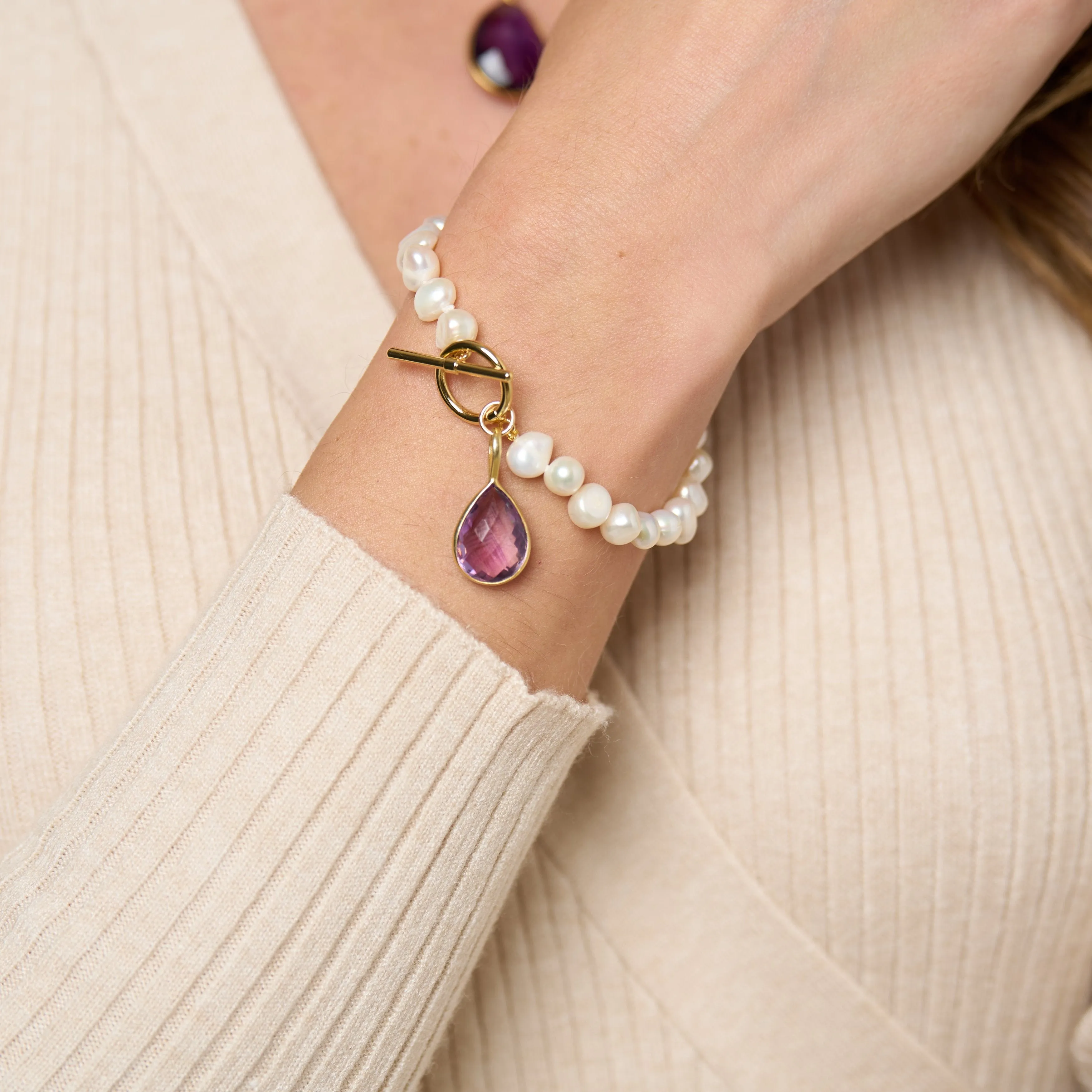 Clara white irregular cultured freshwater pearl bracelet with an amethyst drop pendant